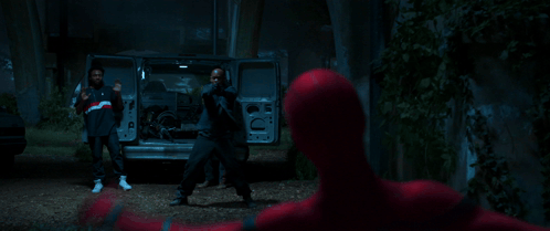 A Man In A Dark Room Is Holding A Gun GIF