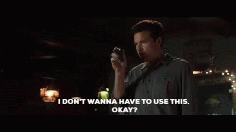 A Man In A Dark Room Is Saying " I Don T Wanna Have To Use This Okay " GIF