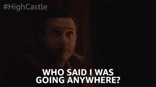 A Man In A Dark Room Says " Who Said I Was Going Anywhere " GIF