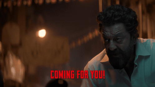a man in a dark room with the words " coming for you " on the bottom