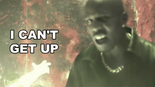 A Man In A Dark Room With The Words I Can 'T Get Up Behind Him GIF