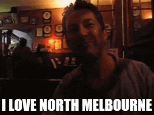 A Man In A Dark Room With The Words I Love North Melbourne Below Him GIF
