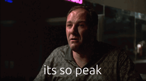 A Man In A Dark Room With The Words It 'S So Peak Below Him GIF