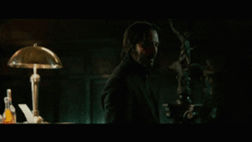 a man in a dark room with the words " not if i see you first " on the screen