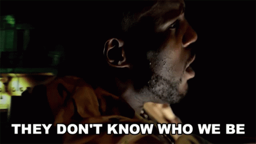A Man In A Dark Room With The Words They Don 'T Know Who We Be Below Him GIF