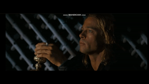 A Man In A Dark Room With The Words We Men Are Wretched Things Above Him GIF
