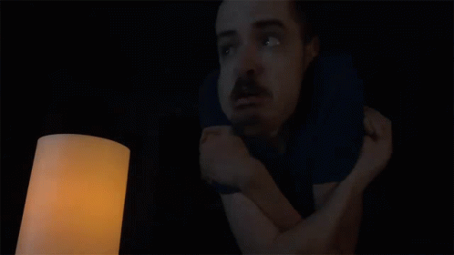 A Man In A Dark Room With The Words When Is The Power Coming Back On Above Him GIF