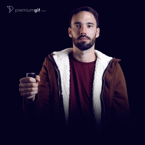 A Man In A Darth Vader Mask Holding A Red Light Saber GIF