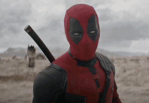 A Man In A Deadpool Costume Holding A Sword GIF