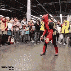A Man In A Deadpool Costume Is Dancing In Front Of A Crowd .. GIF