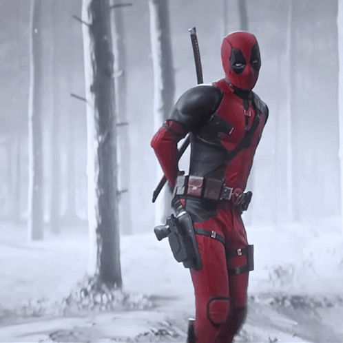 A Man In A Deadpool Costume Is Holding A Sword GIF