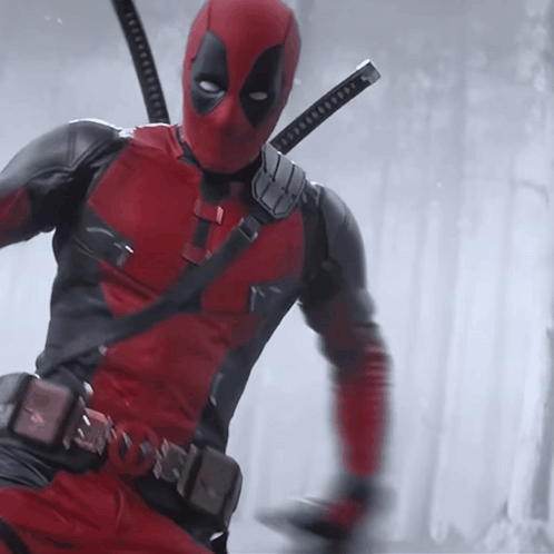 A Man In A Deadpool Costume With Two Swords On His Shoulder GIF
