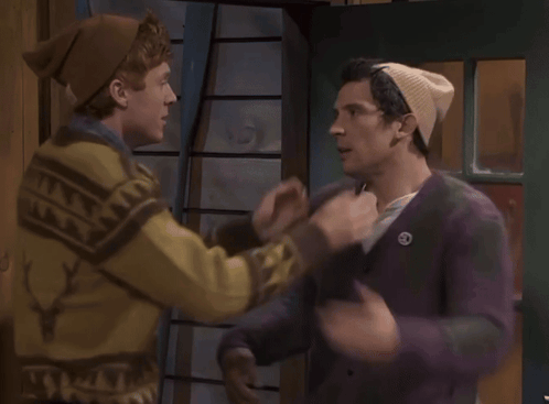 A Man In A Deer Sweater Kisses Another Man GIF