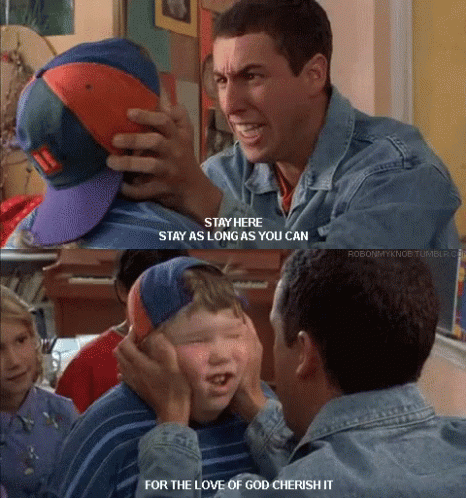 A Man In A Denim Jacket Holds A Boy 'S Hat And Says " Stay Here " GIF