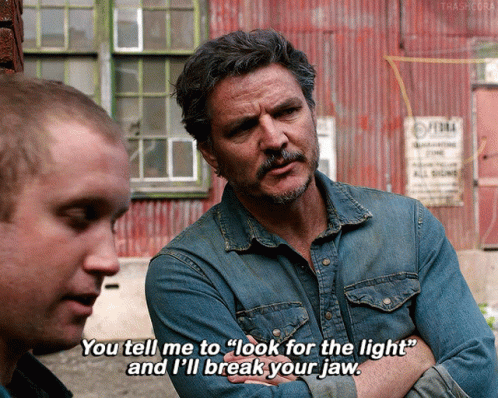 A Man In A Denim Shirt Is Talking To Another Man And Says " You Tell Me To Look For The Light " GIF