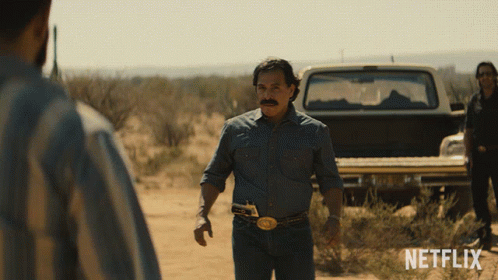 A Man In A Denim Shirt Stands In Front Of A Netflix Truck GIF