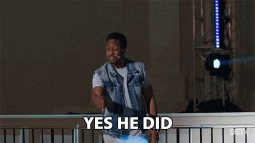 A Man In A Denim Vest Says Yes He Did While Standing On A Balcony GIF