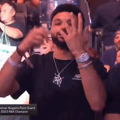 A Man In A Denver Nuggets Point Guard T-Shirt Making A Funny Face GIF
