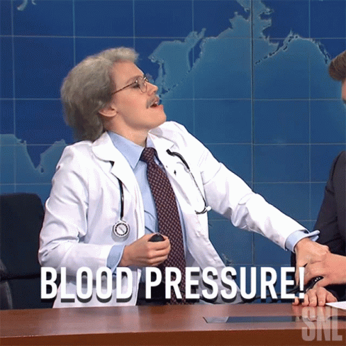 A Man In A Doctor 'S Coat Is Sitting At A Desk And Says Blood Pressure GIF