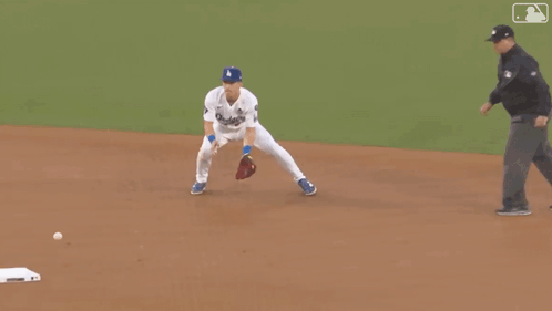 A Man In A Dodgers Jersey Is Running On The Field GIF