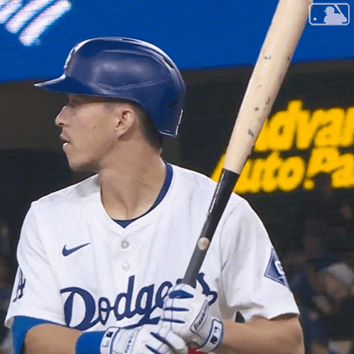A Man In A Dodgers Uniform Holds A Bat GIF