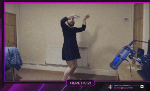 A Man In A Dress Is Dancing In Front Of A Vacuum Cleaner And A Purple Border That Says Heretic121 GIF