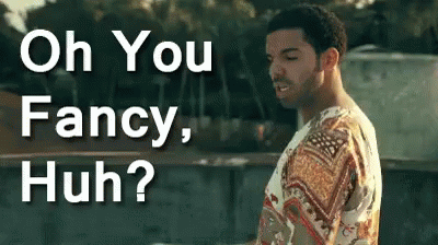 A Man In A Fancy Shirt Is Standing In Front Of A Sign That Says Oh You Fancy Huh ? GIF