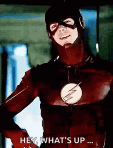 A Man In A Flash Costume Is Standing With His Hands On His Hips And Says `` Hey , What 'S Up ... '' GIF