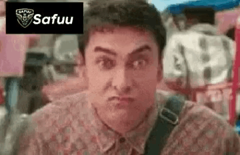 A Man In A Floral Shirt Is Making A Funny Face With His Mouth Open . GIF