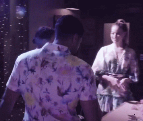 A Man In A Floral Shirt Is Standing Next To A Woman In A Kimono GIF