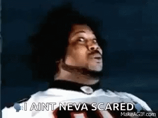 A Man In A Football Jersey Is Looking Up And Saying `` I Ain T Neva Scared '' . GIF