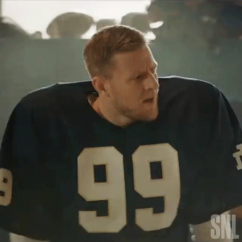 A Man In A Football Jersey With The Number 99 On It . GIF