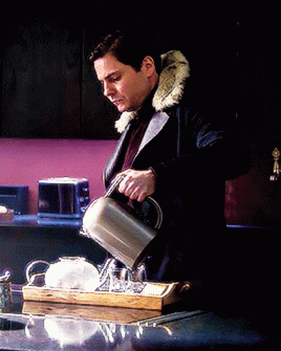A Man In A Fur Coat Is Pouring Tea Into A Cup On A Tray GIF
