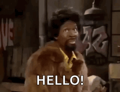 A Man In A Fur Coat Is Saying Hello GIF