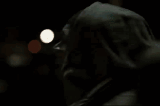 A Man In A Fur Coat Is Talking On A Cell Phone . GIF
