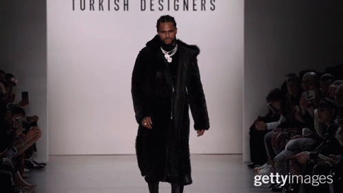 A Man In A Fur Coat Walks Down A Runway At A Turkish Designer 'S Fashion Show GIF