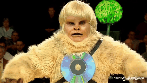 A Man In A Furry Costume Has A Cd On His Chest GIF
