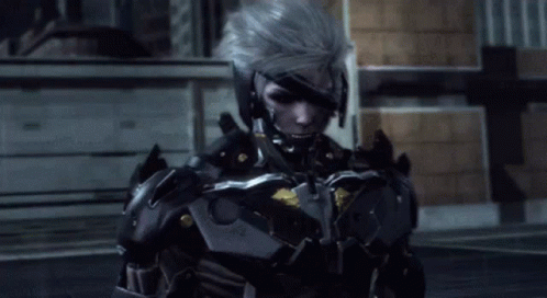 A Man In A Futuristic Armored Suit Is Standing In Front Of A Building GIF