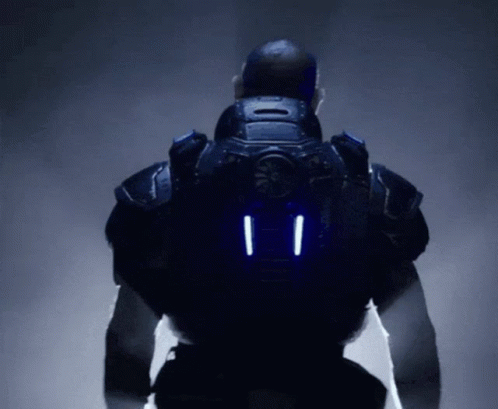 A Man In A Futuristic Suit Has Two Lights On The Back Of His Jacket GIF