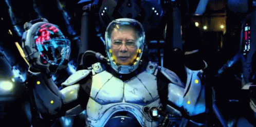 A Man In A Futuristic Suit With A Helmet That Says ' Vc ' On It GIF