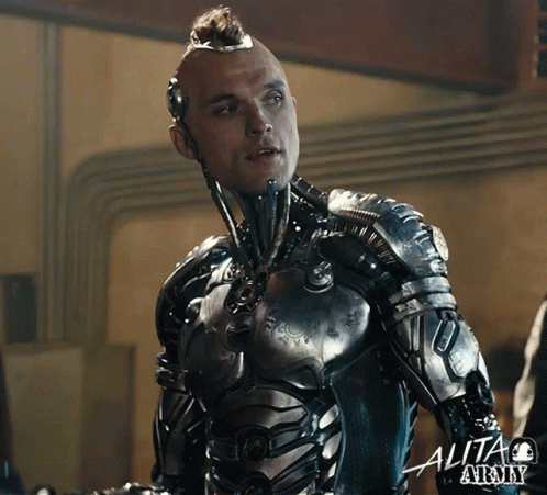 A Man In A Futuristic Suit With The Word Alita At The Bottom Right GIF