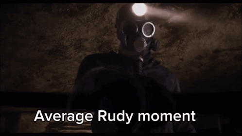 A Man In A Gas Mask Is Holding A Flashlight In A Dark Room With The Words Average Rudy Moment Written Below Him . GIF