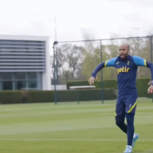 A Man In A Getir Shirt Is Running On A Soccer Field GIF