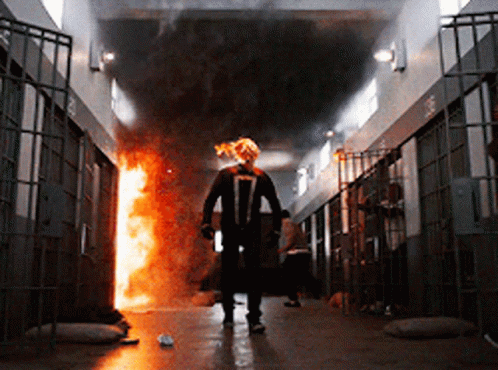 A Man In A Ghost Rider Costume Walks Through A Prison GIF