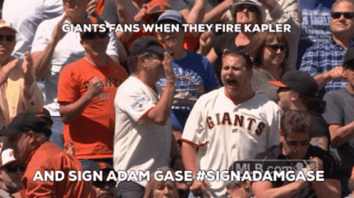 A Man In A Giants Jersey Stands In A Crowd GIF