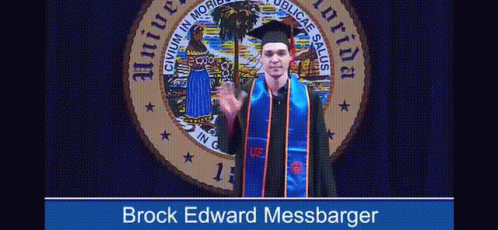 A Man In A Graduation Cap And Gown Stands In Front Of A Florida Seal GIF