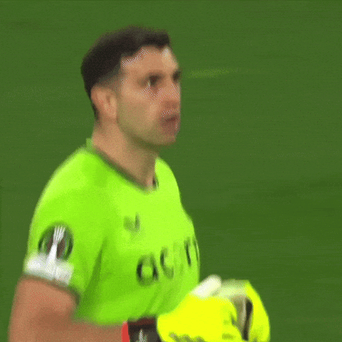 A Man In A Green Acorns Jersey Holds His Gloves Up GIF