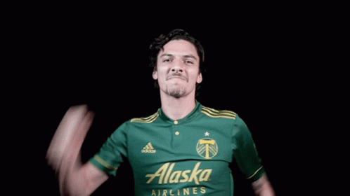 A Man In A Green Alaska Airlines Jersey GIF