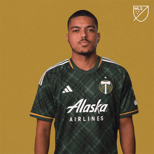 A Man In A Green Alaska Airlines Shirt GIF