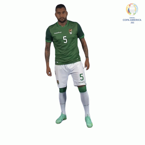 a man in a green and white marathon jersey with the number 5 on it